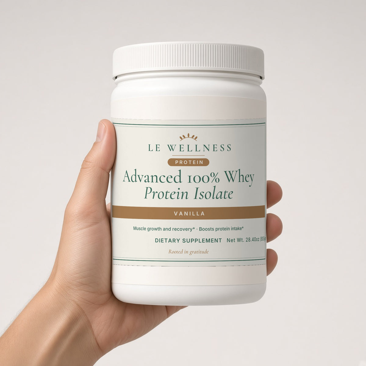 Hand holding Le Wellness Advanced 100% Whey Protein Isolate (Vanilla) tub